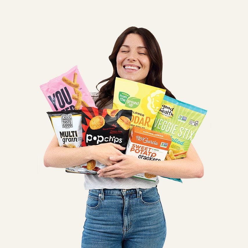 Woman holding six assorted snacks
