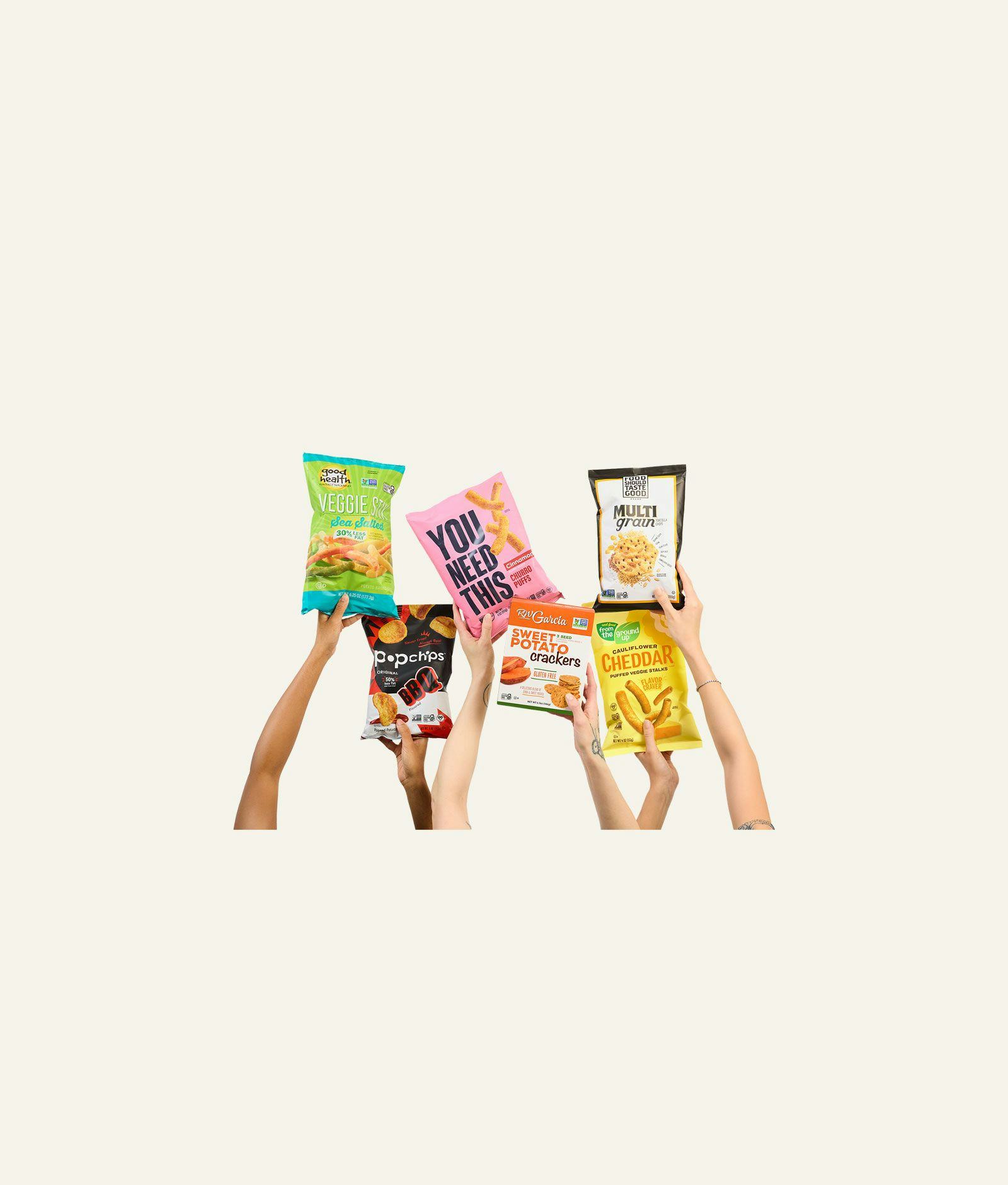 Our Home snack brands held up into the air.