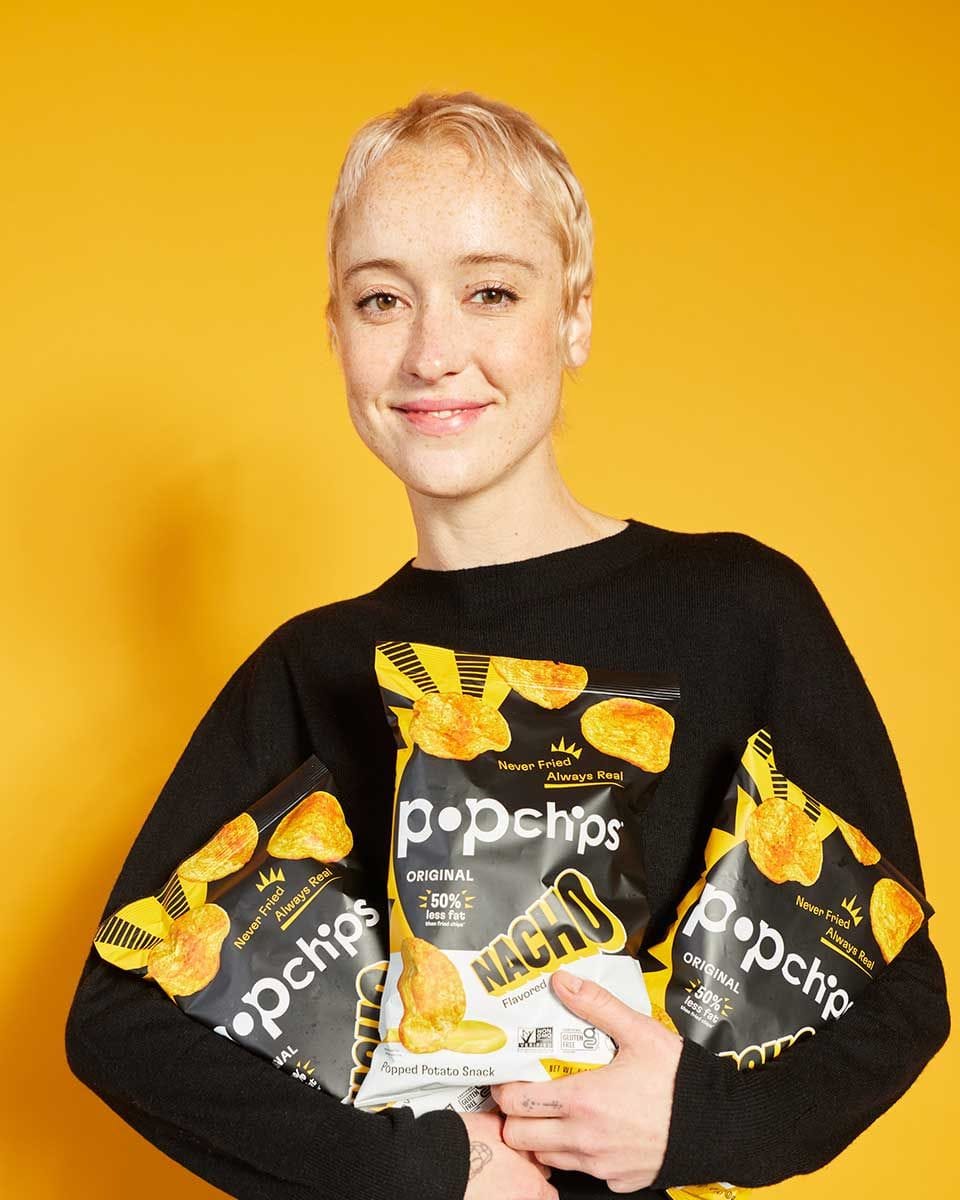 A woman eating Nacho Popchips