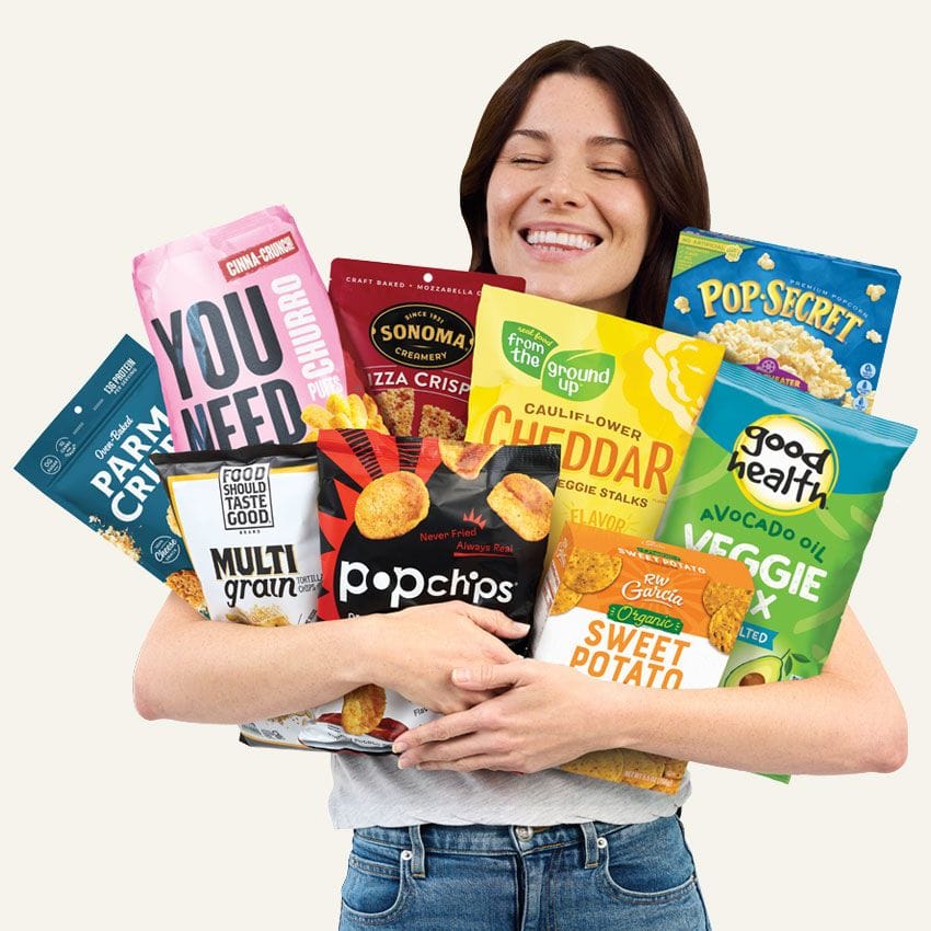 Woman holding nine assorted snacks