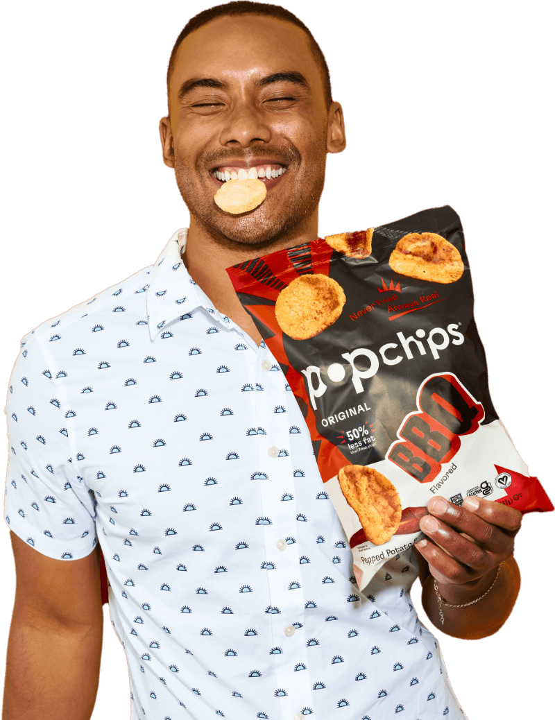 Person holding two bags of Popchips.