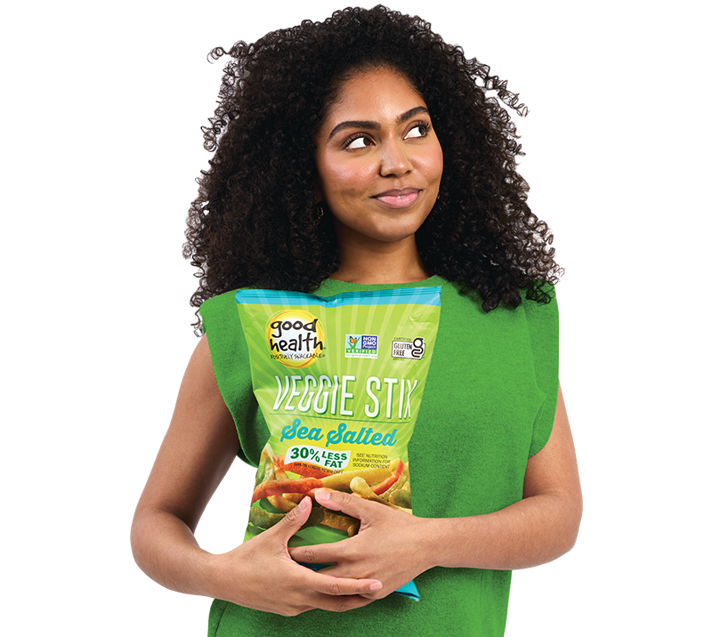 A woman holding a bag of Good Health veggie stix